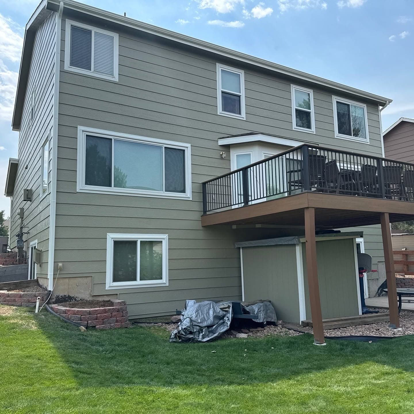 Three-story gray fiber-cement siding with metal deck railings