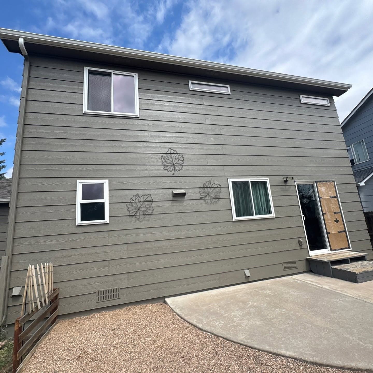 Modern gray-sided house with white trim windows