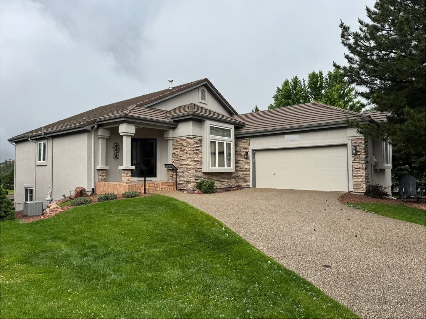 Cream stucco exterior with stone accent columns